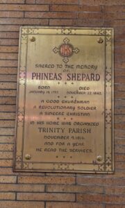 The plaque honoring Phineas Shepard, whose home was the first church